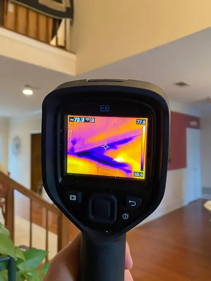 Thermal imaging camera showing a cold, wet area inside a two story home