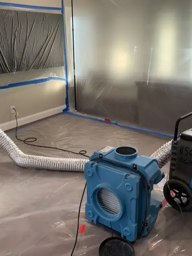 Containment and a dehumidifier set up during a water damage dry-out